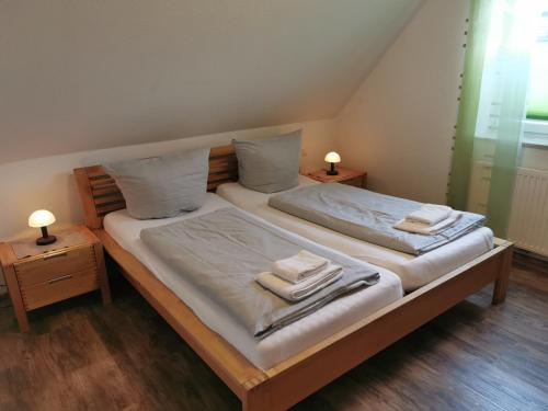- une chambre avec 2 lits et des serviettes dans l'établissement FeWo Goldene Linie, à Wangerland