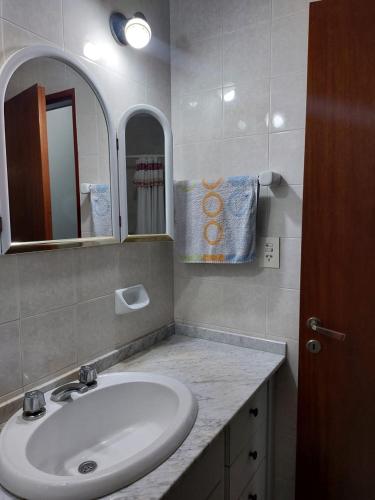 a bathroom with a sink and a mirror at La Porota in Ramallo