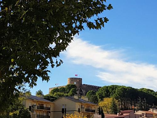 a castle on top of a hill with houses at Casa del Castillo by Naturadrada in La Adrada
