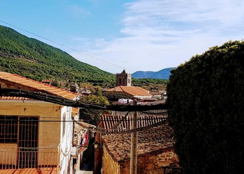 a view of a village with a church in the distance at Casa del Castillo by Naturadrada in La Adrada