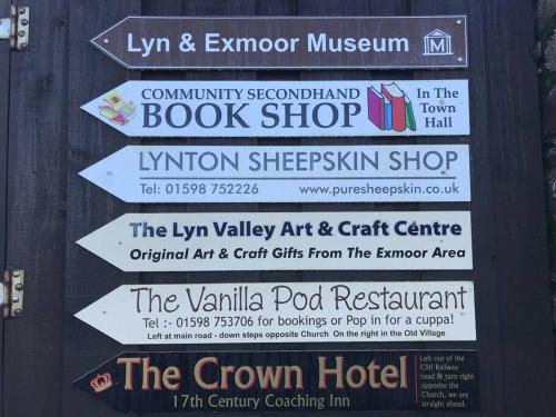a sign for a book shop with signs on it at Lovely flat located in heart of Lynton. in Lynton