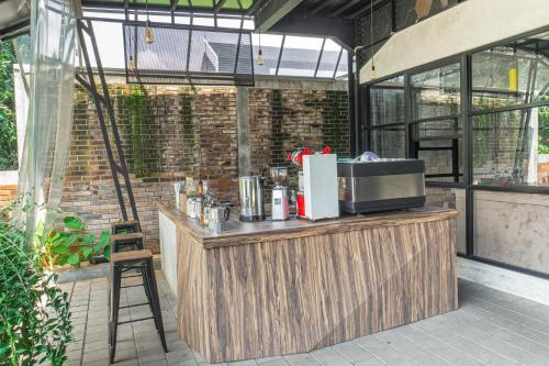 a bar in a greenhouse with a chair next to it at Hotel Summerville in Majalengka