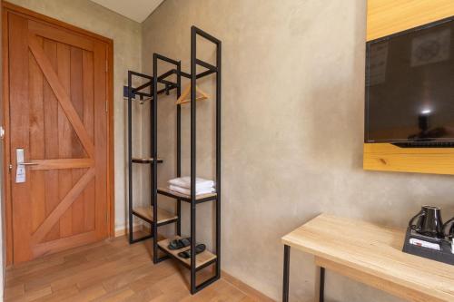 a room with a door and a shelf with towels at Hotel Summerville in Majalengka