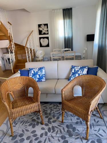 a living room with a couch and two chairs at Cascina Jesolana in Lido di Jesolo
