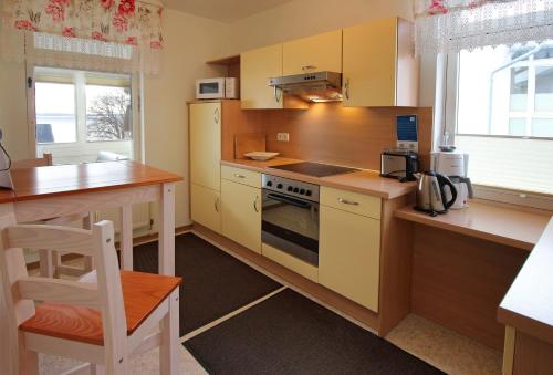 a kitchen with a counter and a stove top oven at Villa Ostseelilie - Appartements mit Balkon und Meerblick in Sassnitz