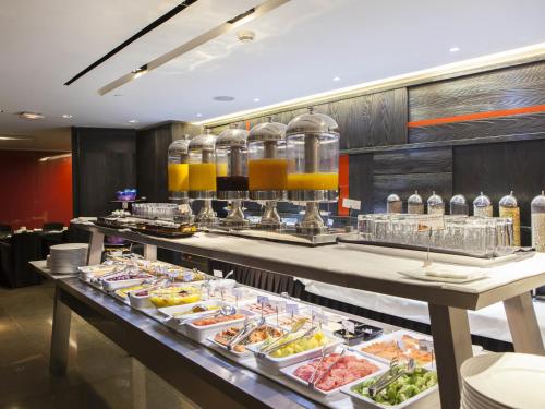 a buffet line with many different types of food at Hotel Puerta America in Madrid