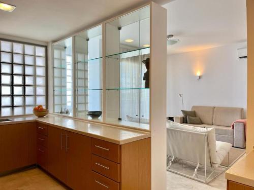 a kitchen with a large mirror and a couch at Charming Tavira - Pools Pet-Friendly Golf in Tavira