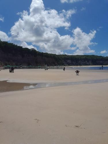 a group of people walking on the beach at Sonia Flats Pipa's Bay - Flat 211 in Pipa
