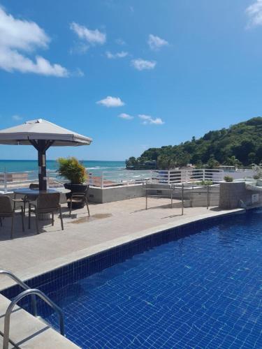 a swimming pool with a view of the beach at Sonia Flats Pipa's Bay - Flat 211 in Pipa