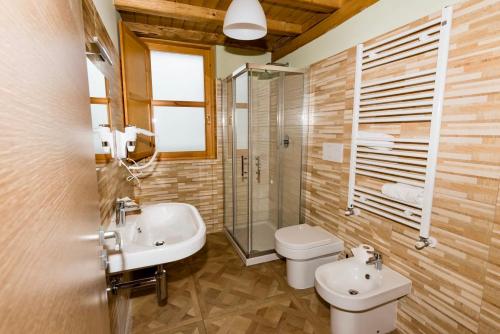 a bathroom with a sink and a toilet and a shower at La Valle del Gran Sasso in Assergi