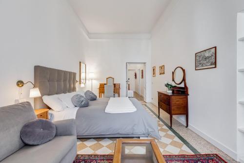 a bedroom with a large bed and a couch at Living Rome Repubblica apartment in Rome