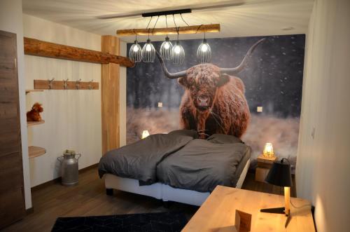 a room with a large bull on the wall at Loft industriel dans une ancienne grange 