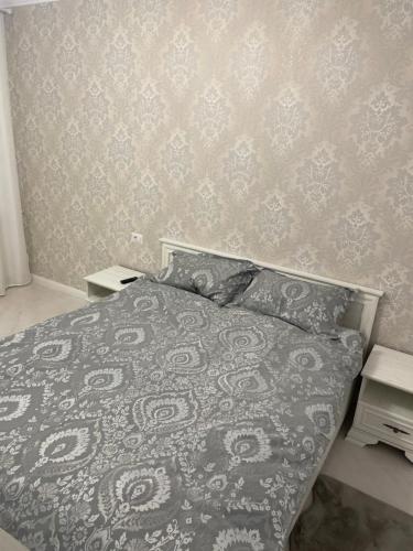 um quarto com uma cama com uma parede estampada em Marasesti Studio em Suceava