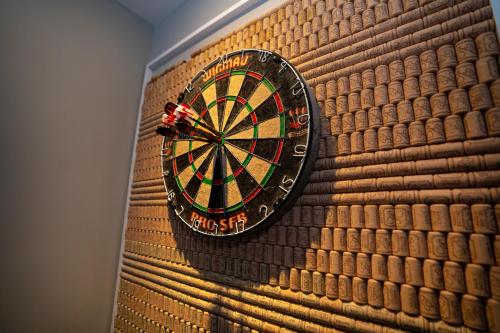 a dart board on the wall of a room at Mountain House in the Heart of Haliburton, Mins to Lake in Haliburton