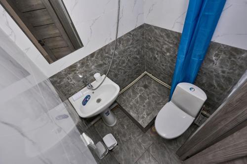an overhead view of a bathroom with a toilet and sink at Апарт 33 in Almaty