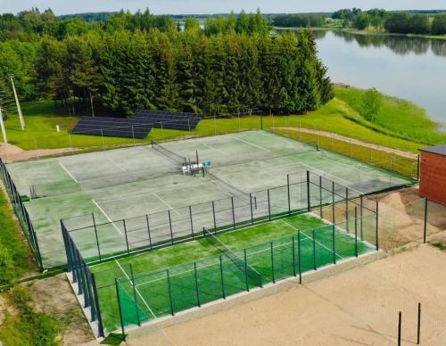 an aerial view of a tennis court next to a lake at Sodyba Brazylija in Taraldžiai