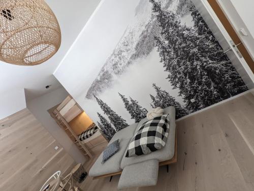 a living room with a couch and a picture on the wall at JASMIN HOME Apartments in Vítkovice