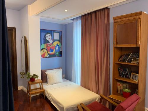 a room with two beds and a painting on the wall at Downtown Italian Studio in Bucharest