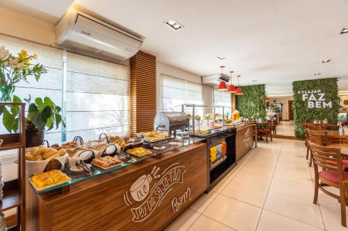 a buffet in a restaurant with a lot of food at Hotel Paradiso del Sol in Cabo Frio