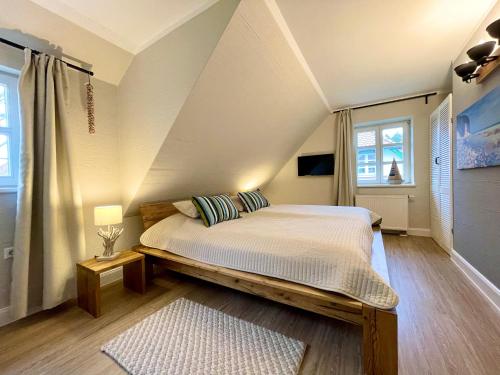a bedroom with a large bed in a attic at Meerluft 10 in Dranske