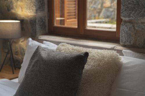 a bedroom with a bed with a pillow and a window at Anastasia's Suites Arcadia in Vytina