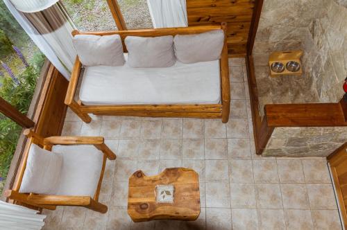 an overhead view of a room with a bed and chairs at BOG Ocrehue - Cabanas in Villa La Angostura