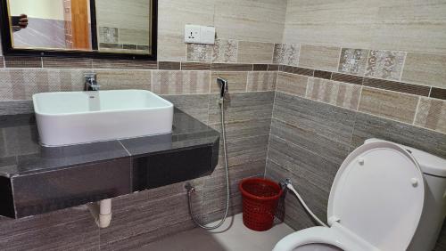a bathroom with a sink and a toilet at Hotel Cox Rotana in Cox's Bazar