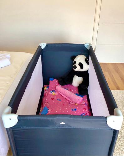 a stuffed panda bear sitting in a crib at Holiday house "Mimoza" 2 massage pools in Otočac