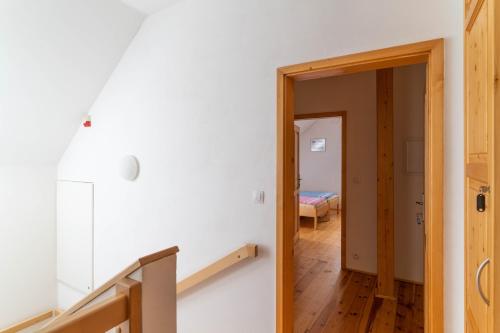 a hallway with a door leading to a bedroom at Penzion U hájovny u pískoven - Vlkov in Vlkov