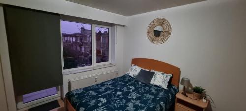 a bedroom with a bed and a large window at SUPERB APPARTEMENT WITH 3 BED ROOMS IN ANTWERPEN in Antwerp