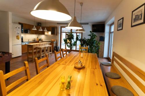 a kitchen and dining room with a wooden table at Penzion U hájovny u pískoven - Vlkov in Vlkov