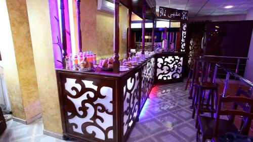 a bar in a room with a counter withmetics at hotel brahimi batna in Batna