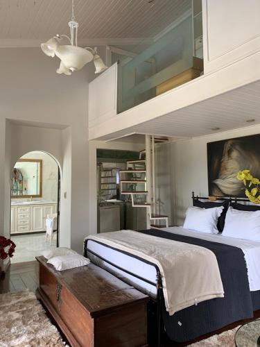 a bedroom with a large bed with a cabinet above it at POUSADA BELA VISTA in Pirenópolis