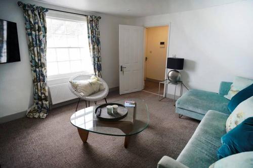 a living room with a couch and a table at Franks, Cowes - Sleeps 4 - 2 Bed - 2 Bath - Central Location in Cowes