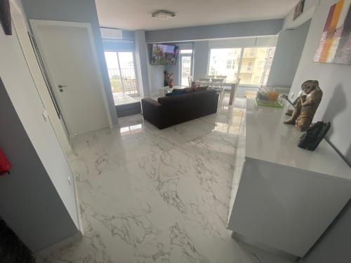 a living room with a marble floor and a living room at SEA FRONT in Armação de Pêra