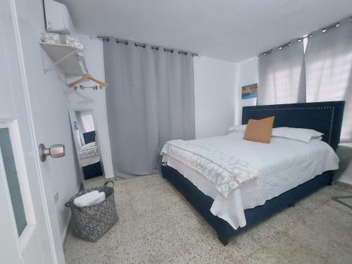 a bedroom with a bed with white sheets and a window at Casa Doña Guilla 2 