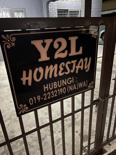 a sign on a fence that reads homogeneoushuing at Traveler Homestay Paka 3-6pax in front Surau and Near Paka Beach - Y2L Homestay 1 in Paka