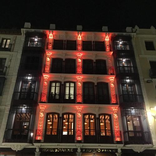 a lit up building with red lights on it at Hotel Boutique ADOLFO in Toledo