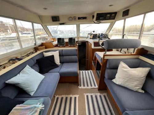 a small boat with blue couches and pillows at Barco Princess Cachucho Fly in Puerto Calero