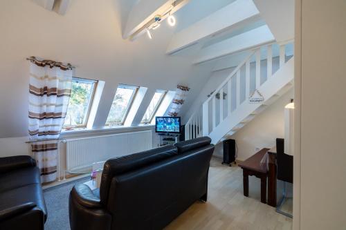 a living room with a couch and a tv at Ferienwohnung Südstrand in Wyk auf Föhr