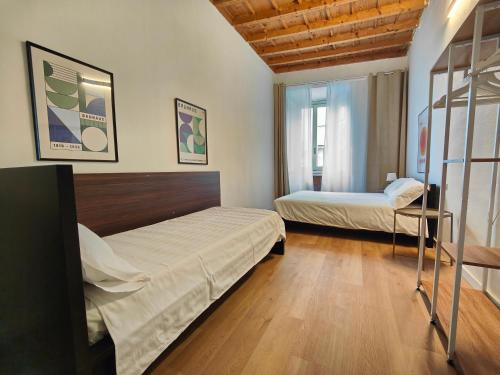 a bedroom with two beds and a window at Crocetta Charme Apartment in Milan