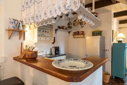 a kitchen with a counter with a plate on it at Ferienwohnung die Scheune in Utersum