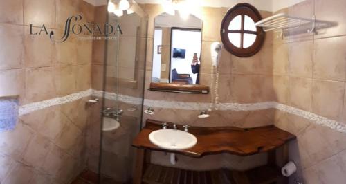 a bathroom with a sink and a mirror at La Soñada Cabañas & Spa in Merlo