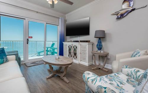 a living room with a couch and a tv at Seawind 809 condo in Gulf Shores