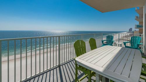 a balcony with a table and chairs on the beach at Seawind 809 condo in Gulf Shores