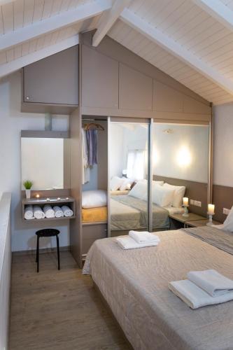 a bedroom with two beds with towels on them at Villa Pearl in Polychrono