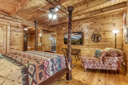 a bedroom with a bed and a chair in a log cabin at Mountain Jewel, Game Room , Fire Pit, Theater Area, WIFI, Pool access!!! in Gatlinburg