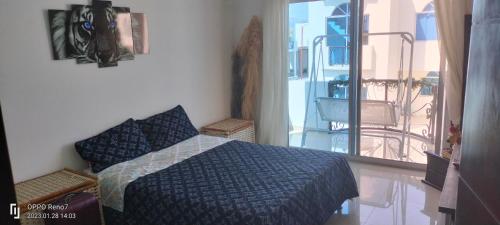 a bedroom with a bed and a balcony at Casa Veraneo Flandes con Piscina Privada in Flandes
