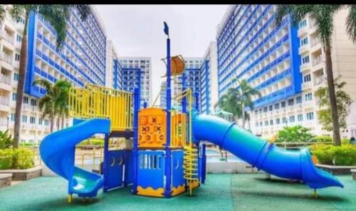 a playground with a slide in a city at Yhanz Z Sea Residences in Manila