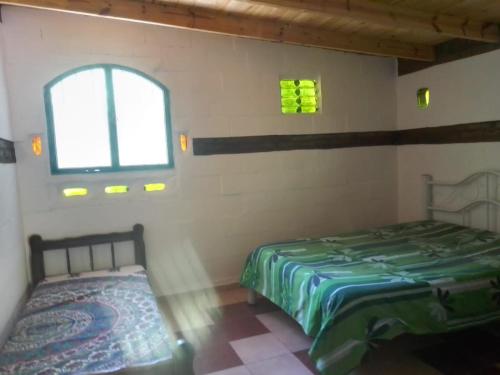 Una cama o camas en una habitación de EL MONTECITO